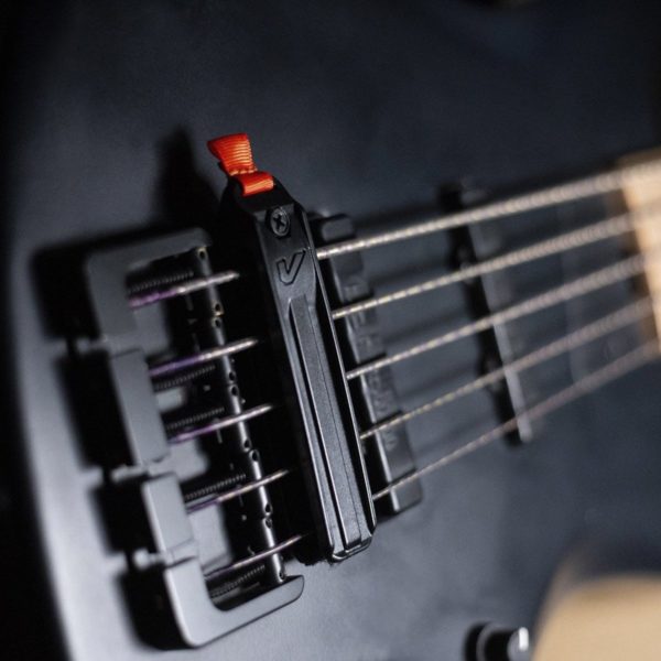 Gruv Gear Fump String Muter in Black shown on guitar bridge